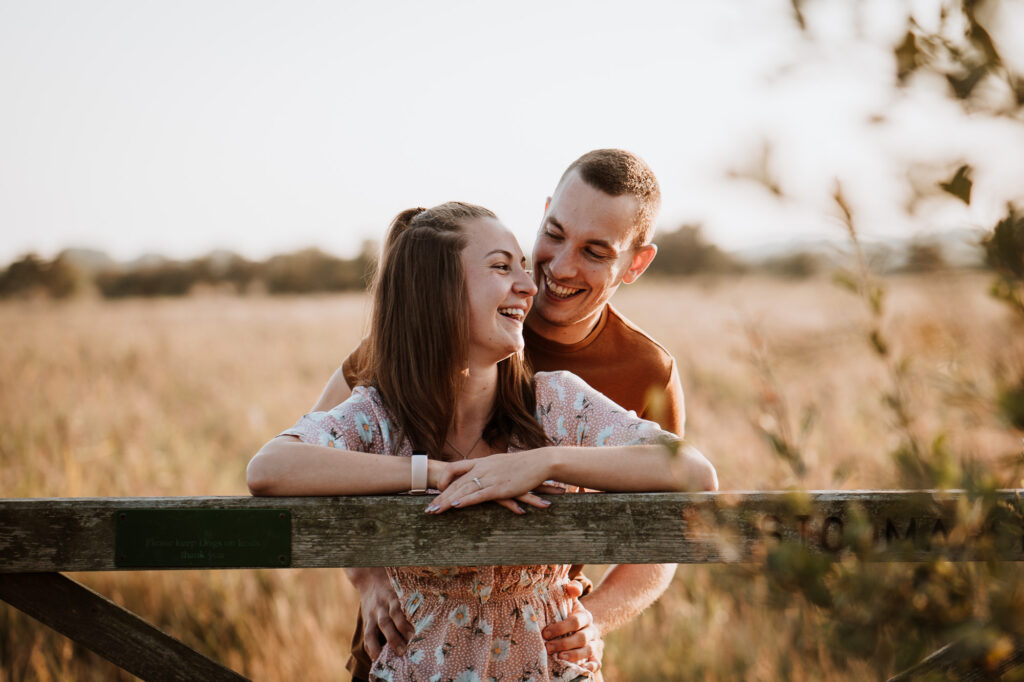 smiling couple in golden hour engagement shoot